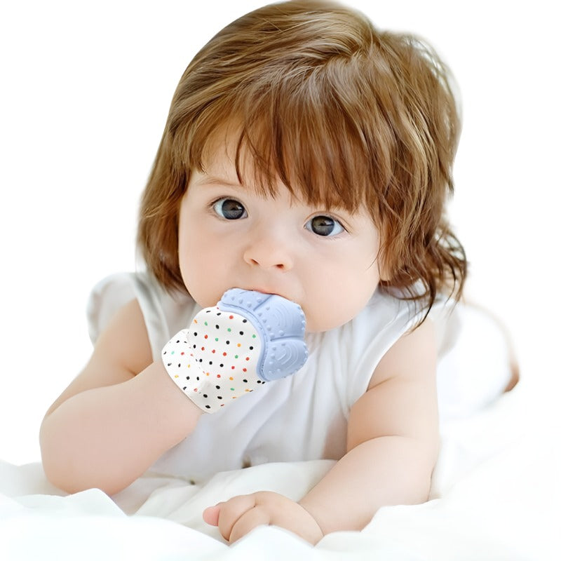 a little girl sitting on a bed holding a teddy bear